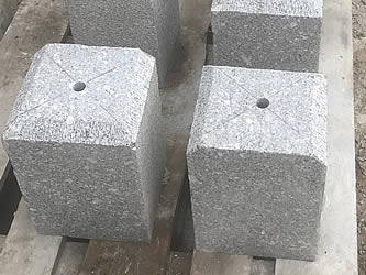 Chamfered granite staddle stones on a pallet