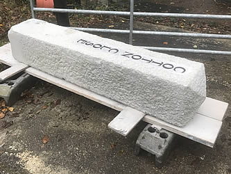 Granite gatepost with handcrafted lettering prior to delivery