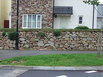 Granite garden wall by pavement