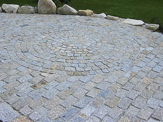 Circular paving using granite setts in patio