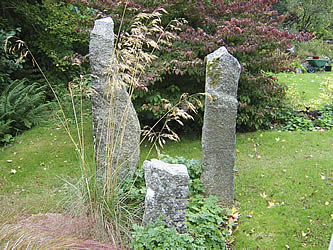 Three granite standing stones of different heights and shape