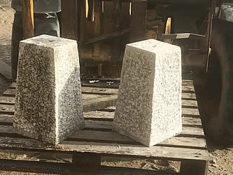 Tappered granite staddle stones on a forklift