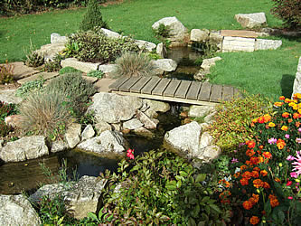 Water feature with bridge and boulders