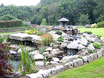 Water feature with granite boulders and garden ornaments